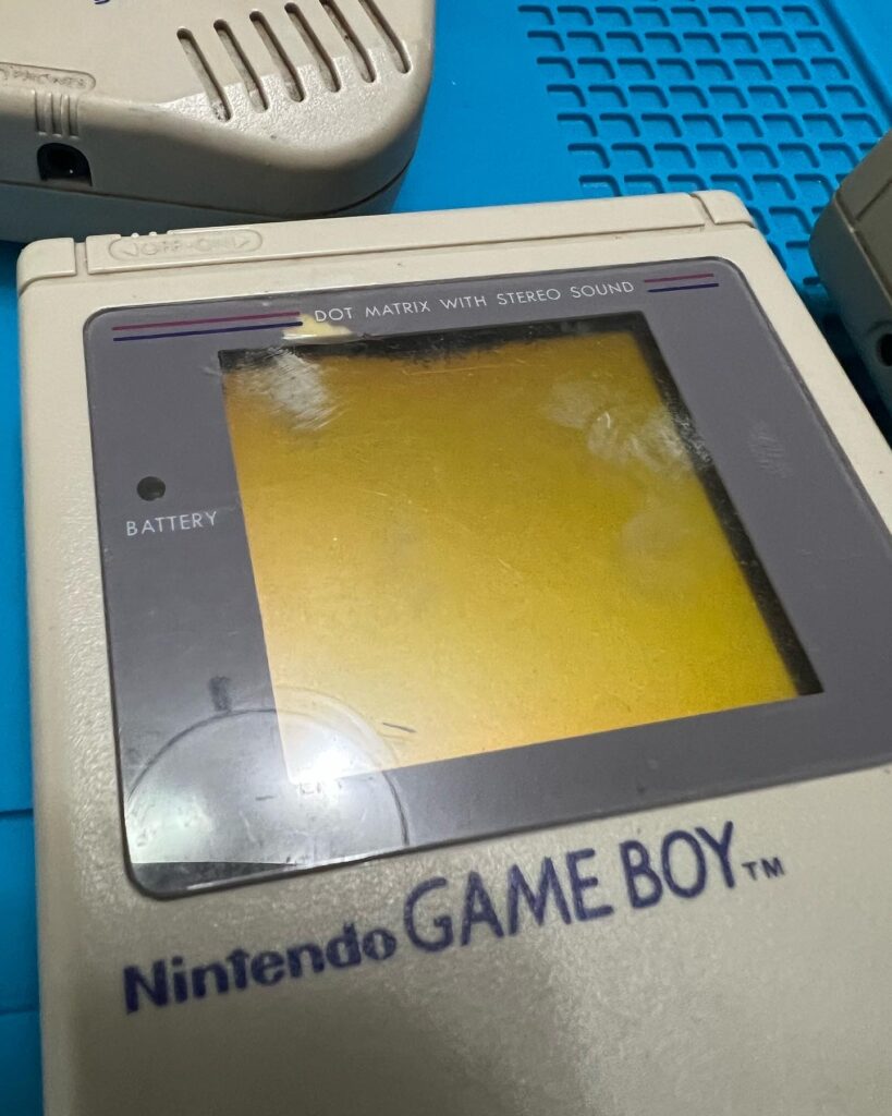 A Game Boy with a scuffed plastic display.