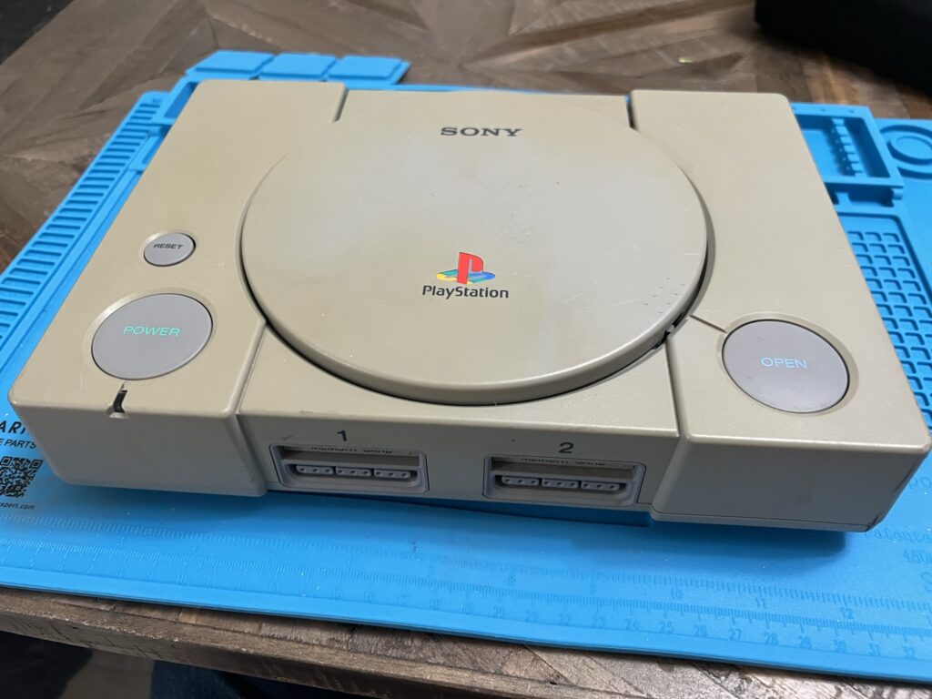 A PlayStation on a work mat.